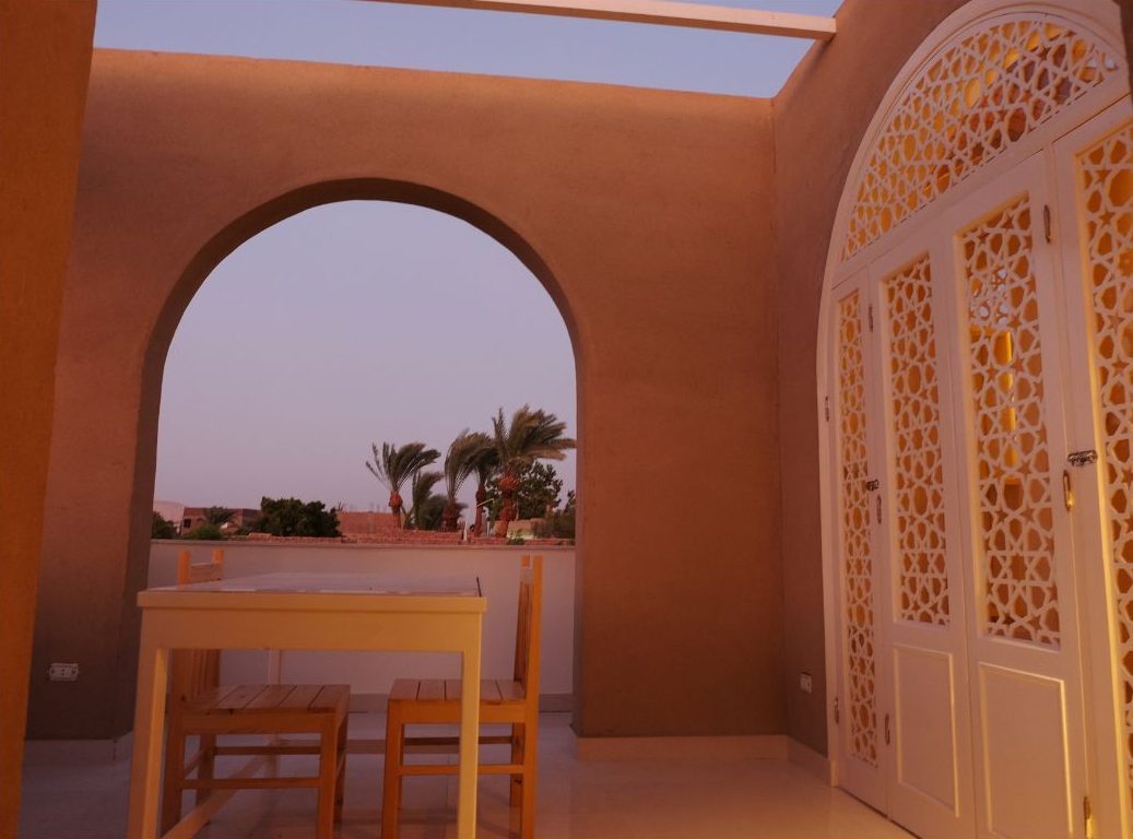 Lit archway and lantern at night