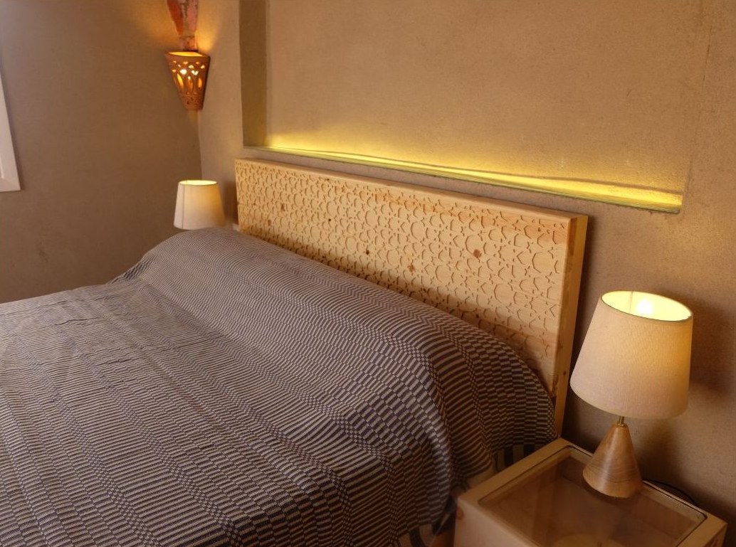 Bedroom with carved wood headboard