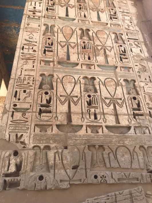 Carved and painted hieroglyph relief on a temple wall