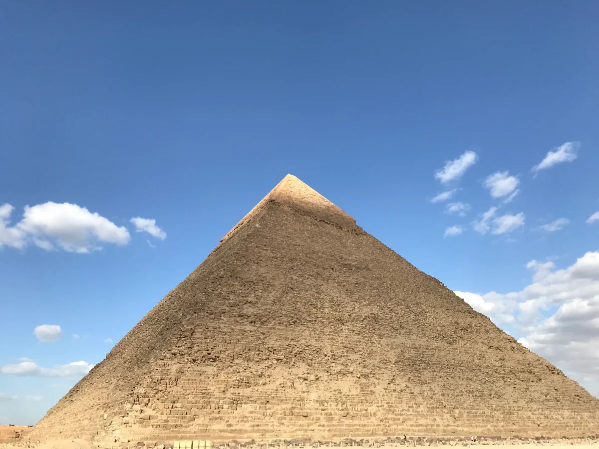 The pyramid of Khafre rising against a bright sky